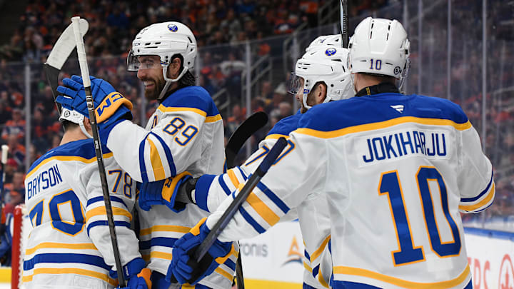 Alex Tuch (89), Jacob Bryson (78), and Henri Jokiharju (10) celebrating a goal against the Edmonton Oilers. 