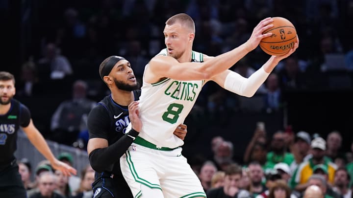 Jun 6, 2024; Boston, Massachusetts, USA; Boston Celtics center Kristaps Porzingis (8) controls the ball against Dallas Mavericks center Daniel Gafford (21) in the first quarter during game one of the 2024 NBA Finals at TD Garden. Mandatory Credit: David Butler II-USA TODAY Sports
