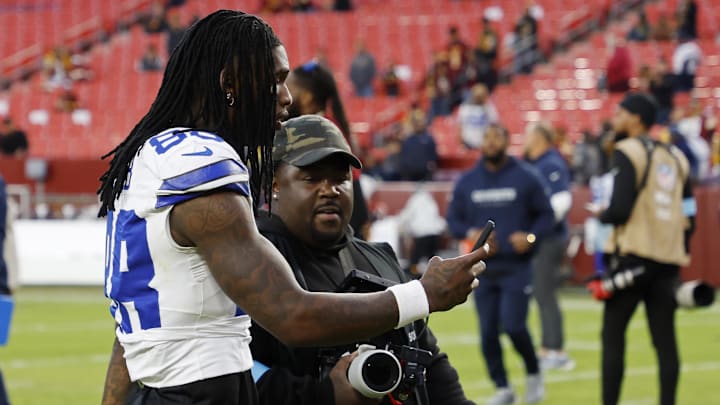Dallas Cowboys wide receiver CeeDee Lamb records a phone video while leaving the field after the Cowboys' game against the Washington Commanders at Northwest Stadium. 