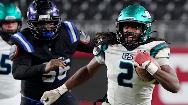 Gulf Shores' Ronnie Royal (2) runs the ball as he is pursued by Ramsay   s Ryan Reese (56) during the 5A AHSAA State Championship Game in Bryant-Denny Stadium Thursday, Dec. 7, 2023. Gulf Shores defeated Ramsay 21-14.