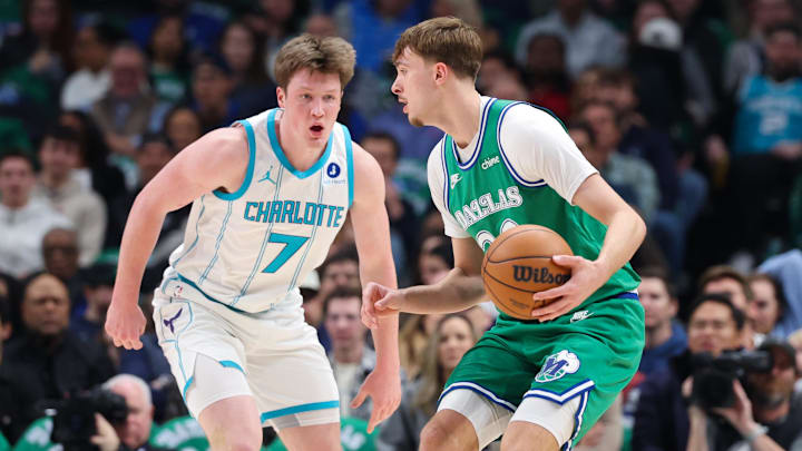 Jan 29, 2026; Dallas, Texas, USA;  Dallas Mavericks forward Cooper Flagg (32) controls the ball as Charlotte Hornets guard Kon Knueppel (7) defends during the first quarter at American Airlines Center. Mandatory Credit: Kevin Jairaj-Imagn Images
