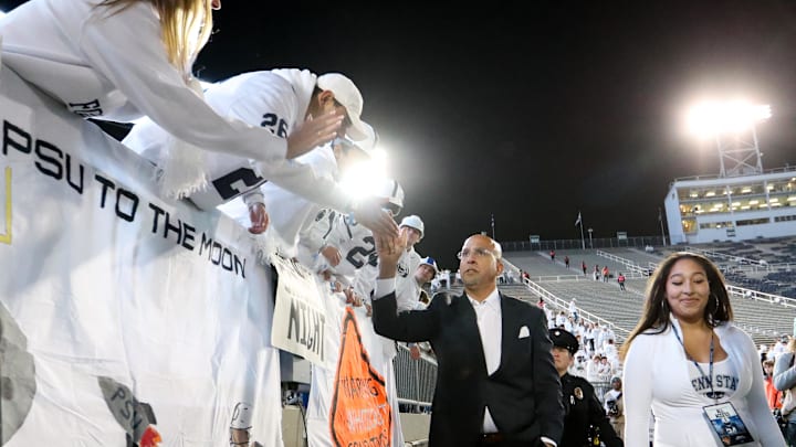 Penn State coach James Franklin shakes hands with the fans upon team arrival prior to the game against the Washington Huskies at Beaver Stadium.