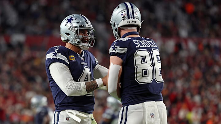 Dallas Cowboys quarterback Dak Prescott reacts with Dallas Cowboys tight end Dalton Schultz after a touchdown.