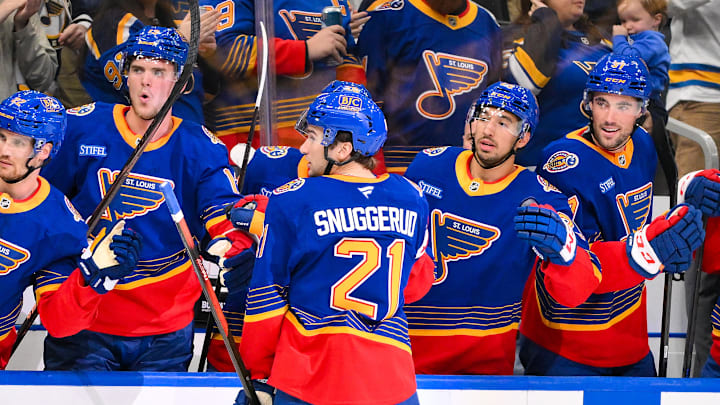 Mar 10, 2026; St. Louis, Missouri, USA; St. Louis Blues right wing Jimmy Snuggerud (21) is congratulated by teammates after scoring against the New York Islanders during the second period at Enterprise Center. Mandatory Credit: Jeff Curry-Imagn Images
