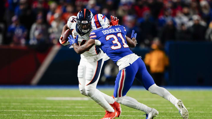 Nov 13, 2023; Orchard Park, New York, USA; Denver Broncos wide receiver Courtland Sutton (14) runs with the ball after making a catch against Buffalo Bills cornerback Rasul Douglas (31) during the second half at Highmark Stadium. 