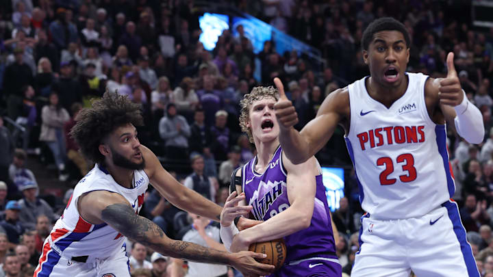 Jan 3, 2024; Salt Lake City, Utah, USA; Detroit Pistons guard Jaden Ivey (23) reacts to a jump ball between Detroit Pistons forward Isaiah Livers (12) and Utah Jazz forward Lauri Markkanen (23) during overtimes at Delta Center. Mandatory Credit: Rob Gray-Imagn Images
