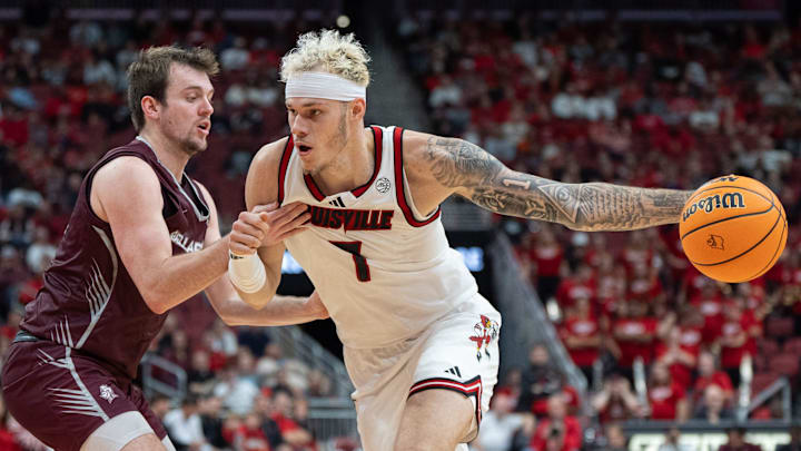 Louisville Cardinals forward Kasean Pryor (7) makes his way around a Bellarmine Knights defender during their game on Tuesday, Nov. 19, 2024 at the KFC Yum! Center in Louisville, Ky.
