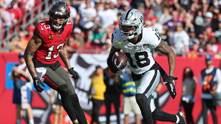 Dec 8, 2024; Tampa, Florida, USA; Las Vegas Raiders cornerback Jack Jones (18) runs with the ball after he intercepted in the end zone against the Tampa Bay Buccaneers during the second quarter at Raymond James Stadium. Mandatory Credit: Kim Klement Neitzel-Imagn Images