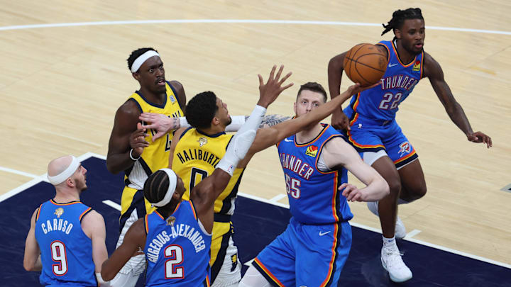 Jun 13, 2025; Indianapolis, Indiana, USA; Indiana Pacers guard Tyrese Haliburton (0) drives to the hoop past Oklahoma City Thunder center Isaiah Hartenstein (55), guard Shai Gilgeous-Alexander (2) and guard Alex Caruso (9) during the second quarter of game four of the 2025 NBA Finals at Gainbridge Fieldhouse. Jun 13, 2025; Indianapolis, Indiana, USA; Indiana Pacers guard Tyrese Haliburton (0) drives to the hoop past Oklahoma City Thunder center Isaiah Hartenstein (55), guard Shai Gilgeous-Alexander (2) and guard Alex Caruso (9) during the second quarter of game four of the 2025 NBA Finals at Gainbridge Fieldhouse.