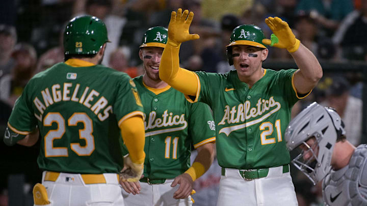 Aug 25, 2025; West Sacramento, California, USA; Athletics catcher Shea Langeliers (23) celebrates with third baseman Brett Harris (11) and outfielder Tyler Soderstrom (21) after hitting a grand slam against the Detroit Tigers during the seventh inning at Sutter Health Park. Mandatory Credit: Ed Szczepanski-Imagn Images