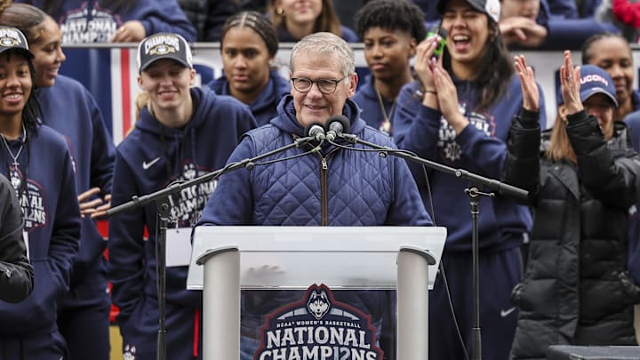 Apr 13, 2025; Hartford, CT, USA;   UConn Huskies head coach Geno Auriemma addresses the crowd while UConn student-athlete Paige Bueckers looks on during the Final Four champions victory parade and rally outside of the XL Center in Hartford, CT. Mandatory Credit: Scott Rausenberger-Imagn Images