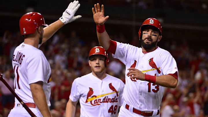 Sep 12, 2017; St. Louis, MO, USA; St. Louis Cardinals third baseman Matt Carpenter (13) celebrates with shortstop Paul DeJong (11) after scoring on a triple by left fielder Tommy Pham (not pictured) during the second inning against the Cincinnati Reds at Busch Stadium. Mandatory Credit: Jeff Curry-Imagn Images