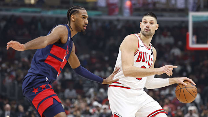 Jan 10, 2025; Chicago, Illinois, USA; Chicago Bulls center Nikola Vucevic (9) drives to the basket against Washington Wizards forward Alexandre Sarr (20) during the first half at United Center. Mandatory Credit: Kamil Krzaczynski-Imagn Images