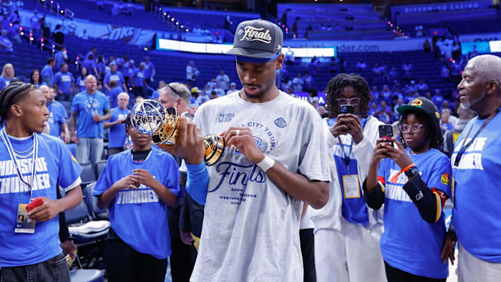 May 28, 2025; Oklahoma City, Oklahoma, USA; Oklahoma City Thunder guard Shai Gilgeous-Alexander (2) looks at his western conference finals MVP trophy after his team defeated the Minnesota Timberwolves in the western conference finals at Paycom Center. Mandatory Credit: Alonzo Adams-Imagn Images May 28, 2025; Oklahoma City, Oklahoma, USA; Oklahoma City Thunder guard Shai Gilgeous-Alexander (2) looks at his western conference finals MVP trophy after his team defeated the Minnesota Timberwolves in the western conference finals at Paycom Center. Mandatory Credit: Alonzo Adams-Imagn Images