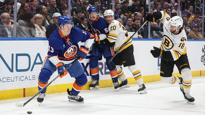 Nov 26, 2025; Elmont, New York, USA; New York Islanders center Mathew Barzal (13) and Boston Bruins center Pavel Zacha (18) battle for control of the puck in the second period at UBS Arena. Mandatory Credit: Wendell Cruz-Imagn Images