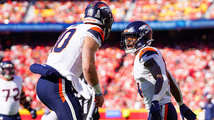 Nov 10, 2024; Kansas City, Missouri, USA; Denver Broncos wide receiver Courtland Sutton (14) celebrates with quarterback Bo Nix (10) after scoring against the Kansas City Chiefs during the first half at GEHA Field at Arrowhead Stadium. 
