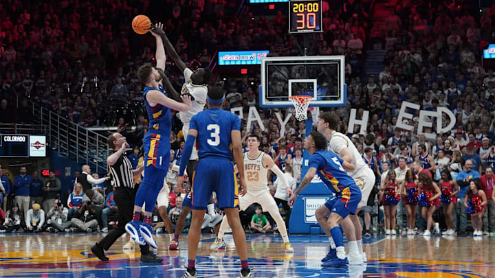 Feb 11, 2025; Lawrence, Kansas, USA; Kansas Jayhawks center Hunter Dickinson (1) and Colorado Buffaloes forward Bangot Dak (8) fight for the opening jump ball during the first half at Allen Fieldhouse. Mandatory Credit: Denny Medley-Imagn Images Feb 11, 2025; Lawrence, Kansas, USA; Kansas Jayhawks center Hunter Dickinson (1) and Colorado Buffaloes forward Bangot Dak (8) fight for the opening jump ball during the first half at Allen Fieldhouse. Mandatory Credit: Denny Medley-Imagn Images