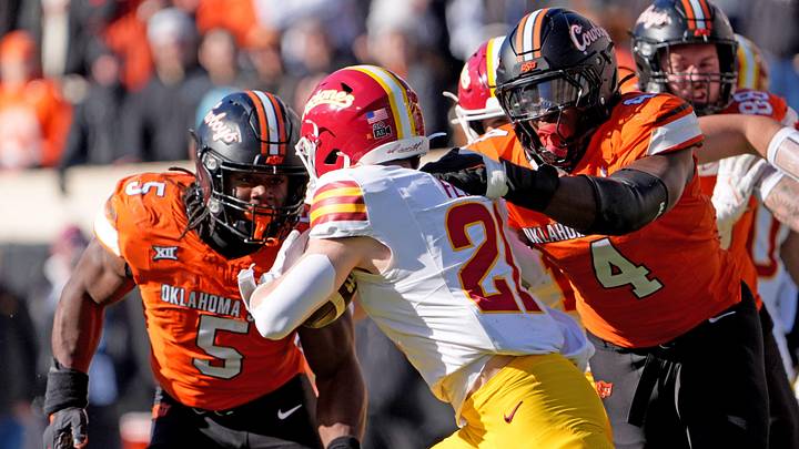 Oklahoma State's Wendell Gregory (4) tackles Iowa State's Aiden Flora (21) in the second half of the college football game between the Oklahoma State Cowboys and the Iowa State Cyclones at Boone Pickens Stadium in Stillwater, Okla., Saturday Nov. 29, 2025.