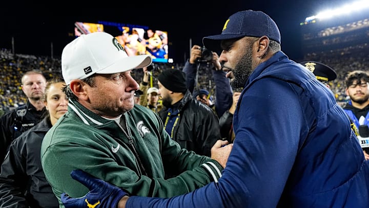 Michigan State head coach Jonathan Smith, left, shakes hands with head coach Sherrone Moore after 24-17 loss at Michigan Stadium in Ann Arbor on Saturday, Oct. 26, 2024.