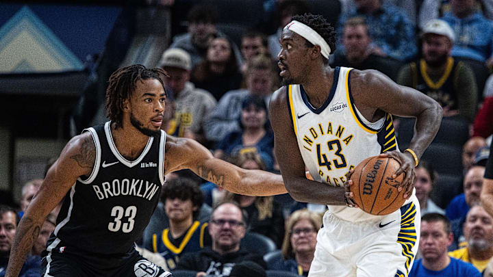 Nov 5, 2025; Indianapolis, Indiana, USA; Indiana Pacers forward Pascal Siakam (43) holds the ball while Brooklyn Nets center Nic Claxton (33) defends in the second half  at Gainbridge Fieldhouse. Mandatory Credit: Trevor Ruszkowski-Imagn Images