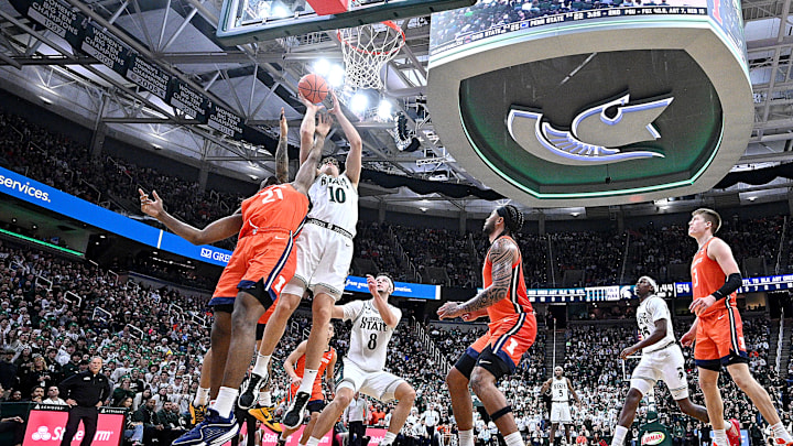 Jan 19, 2025; East Lansing, Michigan, USA;  Michigan State Spartans center Szymon Zapala (10) puts the ball in the basket during the second half against the Illinois Fighting Illini at Jack Breslin Student Events Center. Mandatory Credit: Dale Young-Imagn Images