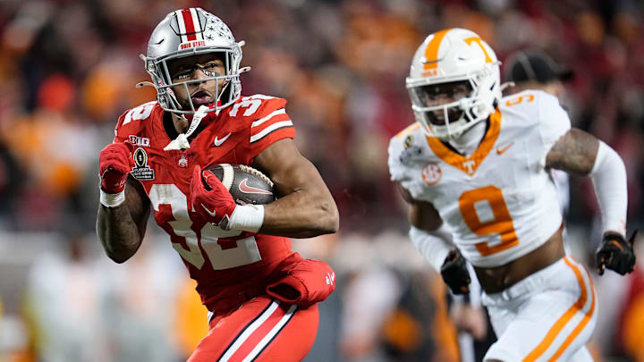 Ohio State Buckeyes running back TreVeyon Henderson (32) runs past Tennessee Volunteers defensive back Jakobe Thomas (9) for a 24-yard touchdown during the second half of the College Football Playoff first round game at Ohio Stadium in Columbus on Dec. 22, 2024. Ohio State won 42-17. Ohio State Buckeyes running back TreVeyon Henderson (32) runs past Tennessee Volunteers defensive back Jakobe Thomas (9) for a 24-yard touchdown during the second half of the College Football Playoff first round game at Ohio Stadium in Columbus on Dec. 22, 2024. Ohio State won 42-17.