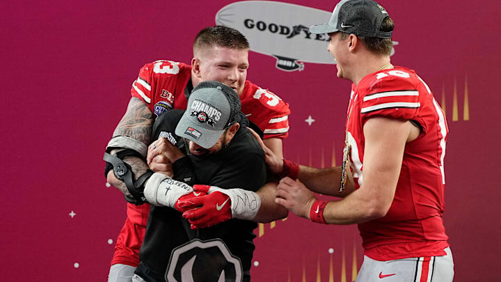 Ohio State Buckeyes head coach Ryan Day celebrates with defensive end Jack Sawyer and quarterback Will Howard. Ohio State Buckeyes head coach Ryan Day celebrates with defensive end Jack Sawyer and quarterback Will Howard.