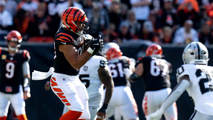 Cincinnati Bengals tight end Erick All Jr. (83) catches a pass for a first down as Las Vegas Raiders running back Sincere McCormick (28) goes to tackle him in the second quarter of the NFL game at Paycor Stadium in Cincinnati on Sunday, Nov. 3, 2024.