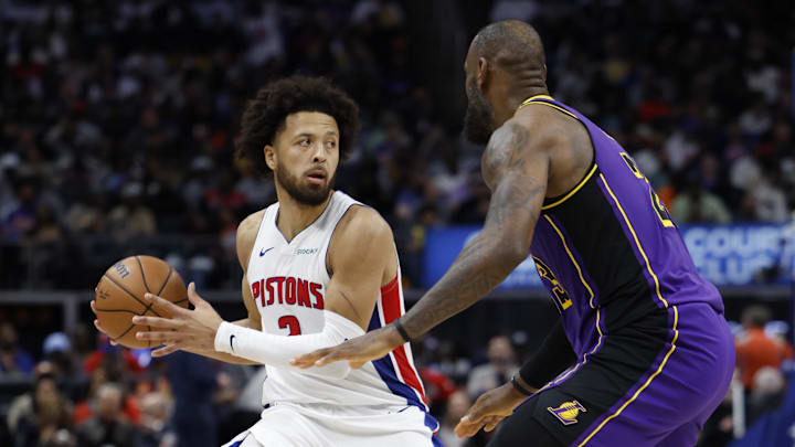 Nov 4, 2024; Detroit, Michigan, USA;  Detroit Pistons guard Cade Cunningham (2) is defended by Los Angeles Lakers forward LeBron James (23): Rick Osentoski-Imagn Images