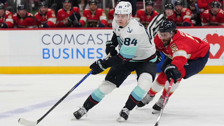Feb 22, 2025; Sunrise, Florida, USA; Seattle Kraken right wing Kaapo Kakko (84) controls the puck as Florida Panthers defenseman Aaron Ekblad (5) closes in during the first period at Amerant Bank Arena. Mandatory Credit: Jim Rassol-Imagn Images Feb 22, 2025; Sunrise, Florida, USA; Seattle Kraken right wing Kaapo Kakko (84) controls the puck as Florida Panthers defenseman Aaron Ekblad (5) closes in during the first period at Amerant Bank Arena. Mandatory Credit: Jim Rassol-Imagn Images