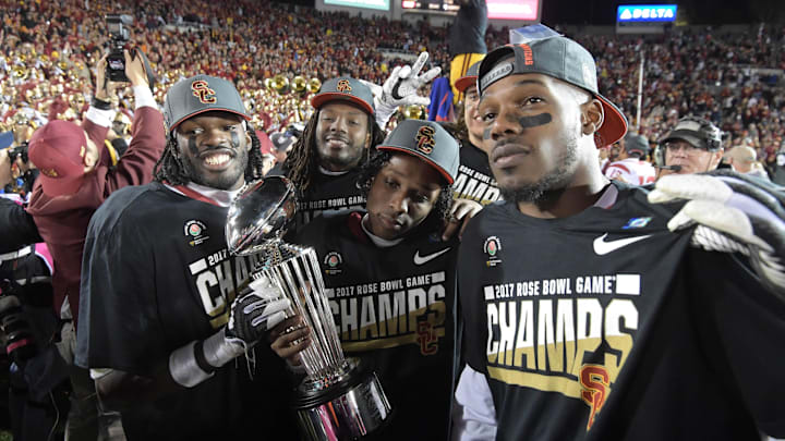 Jan 2, 2017; Pasadena, CA, USA; USC Trojans defensive back Leon McQuay III (22) and defensive back Adoree' Jackson (2) pose with the Leishman Trophy after the 103rd Rose Bowl against the Penn State Nittany Lions at Rose Bowl. USC defeated Penn State 52-49 in the highest scoring game in Rose Bowl history. 
