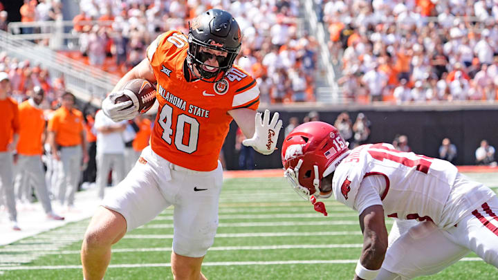Oklahoma State's Josh Ford (40) looks to get past Arkansas' Jaheim Singletary (15) in the second half of the college football game between the Oklahoma State Cowboys and the Arkansas Razorbacks at Boone Pickens Stadium in Stillwater, Okla.,, Saturday, Sept., 7, 2024. Oklahoma State's Josh Ford (40) looks to get past Arkansas' Jaheim Singletary (15) in the second half of the college football game between the Oklahoma State Cowboys and the Arkansas Razorbacks at Boone Pickens Stadium in Stillwater, Okla.,, Saturday, Sept., 7, 2024.