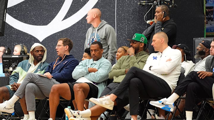 July 19, 2025; North Augusta, South Carolina, USA; NBA star Carmelo Anthony (center right) talks to University of Kentucky basketball coach Mark Pope (right) during the Team Why Not and Team CP3 game at the Nike EYBL Peach Jam at Riverview Park Activity Center. Team Why Not won 66-63. Mandatory Credit: Katie Goodale - Augusta Chronicle/USA TODAY NETWORK