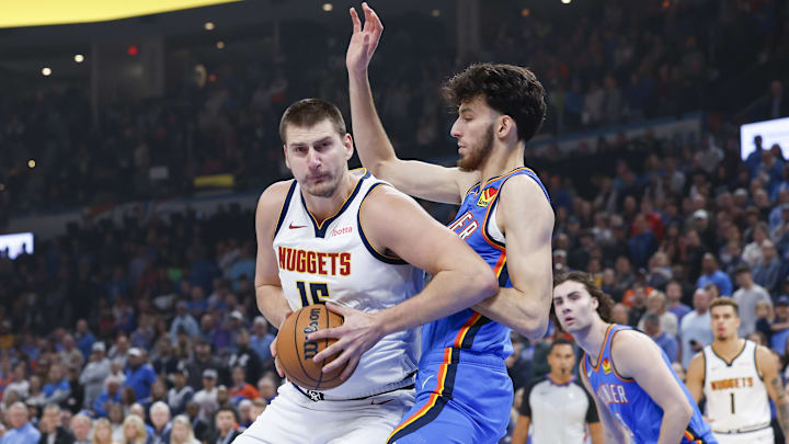 Oct 29, 2023; Oklahoma City, Oklahoma, USA; Denver Nuggets center Nikola Jokic (15) drives to the basket against Oklahoma City Thunder forward Chet Holmgren (7) during the first quarter at Paycom Center. Mandatory Credit: Alonzo Adams-Imagn Images