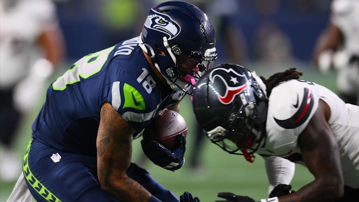 Seattle Seahawks tight end Elijah Arroyo (18) is tackled by Houston Texans safety Calen Bullock (2).