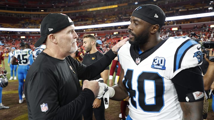 Washington Commanders head coach Dan Quinn (L) talks with Carolina Panthers linebacker Charles Harris (40) after their game at Northwest Stadium. Washington Commanders head coach Dan Quinn (L) talks with Carolina Panthers linebacker Charles Harris (40) after their game at Northwest Stadium.