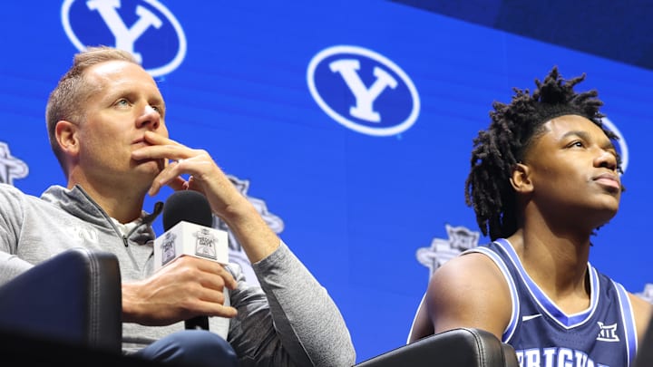 Oct 22, 2025; Kansas City, MO, USA; BYU head coach Kevin Young (left) and Robert Wright III (right) speak to media during Big 12 Menís Basketball media day at T-Mobile Center. Mandatory Credit: Sophia Scheller-Imagn Images