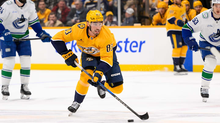 Jan 29, 2025; Nashville, Tennessee, USA;  Nashville Predators defenseman Adam Wilsby (83) skates with the puck against the Vancouver Canucks during the first period at Bridgestone Arena. Mandatory Credit: Steve Roberts-Imagn Images