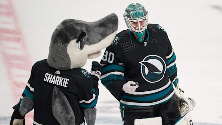 Mar 9, 2024; San Jose, California, USA; San Jose Sharks goaltender Magnus Chrona (30) celebrates with San Jose Sharks mascot Sharkie after defeating the against the Ottawa Senators during the third period at SAP Center at San Jose. Mandatory Credit: Robert Edwards-Imagn Images