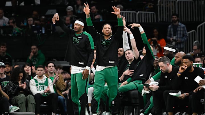 Apr 11, 2025; Boston, Massachusetts, USA; Boston Celtics forward Torrey Craig (12) (left) ad guard JD Davison (20) (right) react to game action against the Charlotte Hornets during the second half at TD Garden. Mandatory Credit: Eric Canha-Imagn Images