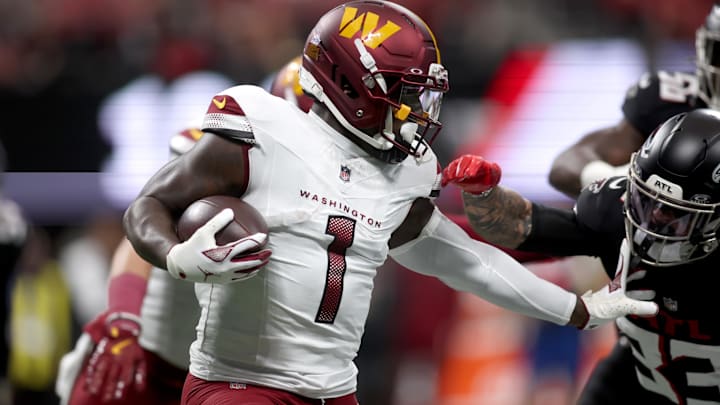 Sep 28, 2025; Atlanta, Georgia, USA; Washington Commanders wide receiver Deebo Samuel Sr. (1) runs against Atlanta Falcons safety Billy Bowman Jr. (33) during the first quarter at Mercedes-Benz Stadium. 