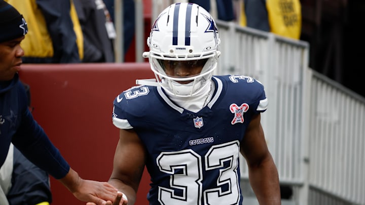 Dallas Cowboys running back Javonte Williams runs onto the field for warmups before the game against the Washington Commanders 