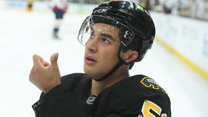 Sep 21, 2025; Boston, Massachusetts, USA; Boston Bruins center Matthew Poitras (51) shows the official blood from his mouth after getting hit in the mouth during the third period against the Washington Capitals at TD Garden. Mandatory Credit: Bob DeChiara-Imagn Images
