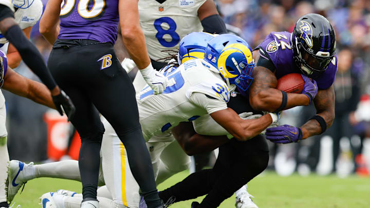 Oct 12, 2025; Baltimore, Maryland, USA; Los Angeles Rams safety Quentin Lake (37) tackles Baltimore Ravens running back Derrick Henry (22) during the second quarter of the game at M&T Bank Stadium. Mandatory Credit: Peter Casey-Imagn Images