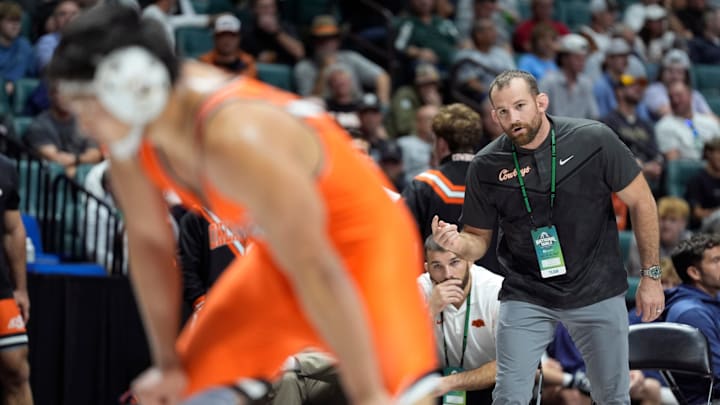 Oklahoma State coach David Taylor talks with Cody Merrill during the National Duals Invitational at the BOK Center in Tulsa, Okla, Saturday, Nov. 15, 2025.