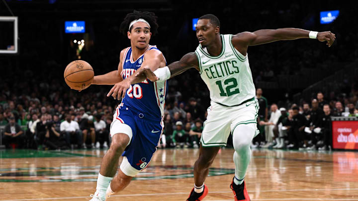 Oct 12, 2024; Boston, Massachusetts, USA; Philadelphia 76ers guard Jared McCain (20) drives to the basket against Boston Celtics guard Lonnie Walker IV (12) during the first half at the TD Garden. Mandatory Credit: Brian Fluharty-Imagn Images