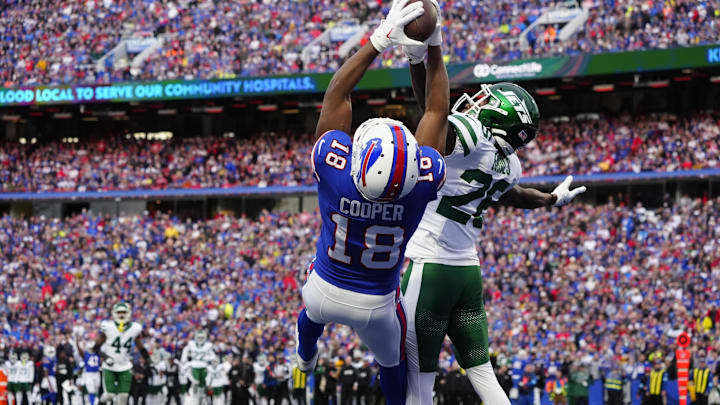 Dec 29, 2024; Orchard Park, New York, USA; Buffalo Bills wide receiver Amari Cooper (18) makes a catch for a touchdown against New York Jets cornerback Brandin Echols (26) during the second half at Highmark Stadium. Mandatory Credit: Gregory Fisher-Imagn Images