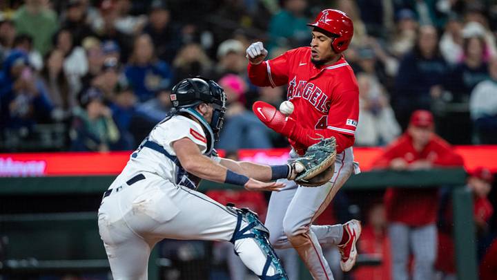 Sep 26, 2026; Seattle, Washington, USA; Los Angeles Angels second baseman Christian Moore (4) scores a run as the ball gets away from Seattle Mariners catcher Cal Raleigh (29) during the sixth inning at T-Mobile Park. Mandatory Credit: Stephen Brashear-Imagn Images Sep 26, 2026; Seattle, Washington, USA; Los Angeles Angels second baseman Christian Moore (4) scores a run as the ball gets away from Seattle Mariners catcher Cal Raleigh (29) during the sixth inning at T-Mobile Park. Mandatory Credit: Stephen Brashear-Imagn Images
