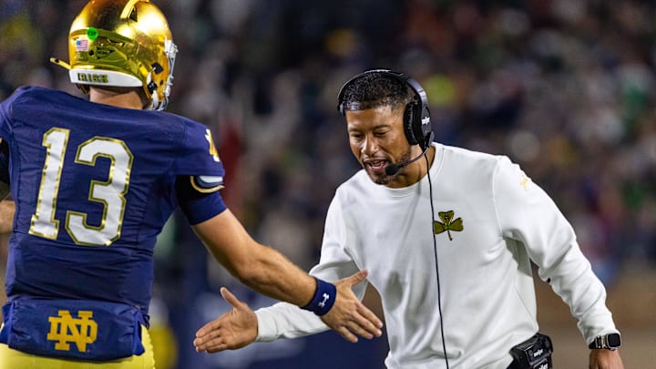 Oct 18, 2025; South Bend, Indiana, USA; Notre Dame Fighting Irish head coach Marcus Freeman celebrates with quarterback CJ Carr (13) during the first half against the Southern California Trojans at Notre Dame Stadium. Mandatory Credit: Michael Caterina-Imagn Images