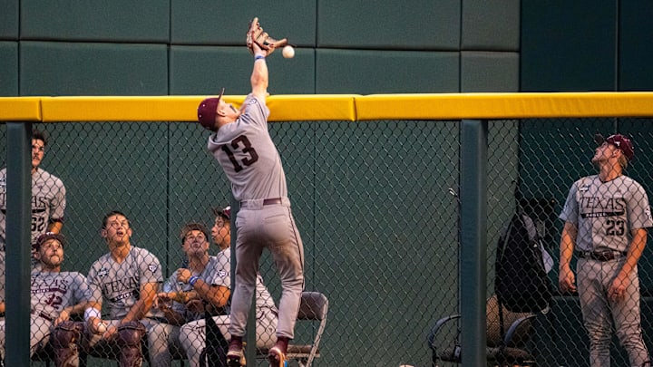 Texas A&M Aggies left fielder Caden Sorrell (13) goes up for the home run ball